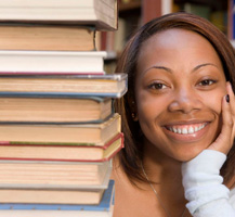 Young woman with a stack of books